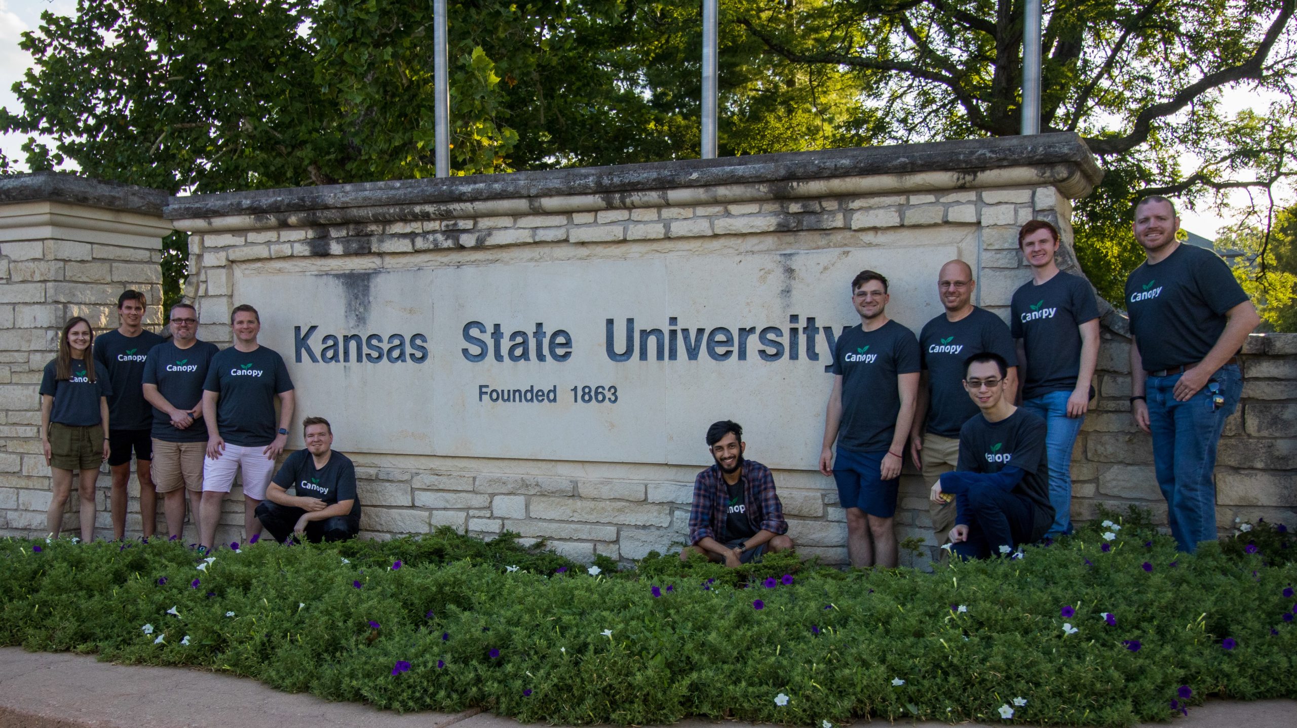 Canopy team in front of Kansas State University sign